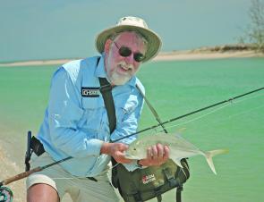 Ken Stein with a fiesty brassy trevally taken while flycasting off the beach on a beautiful late season Weipa morning.